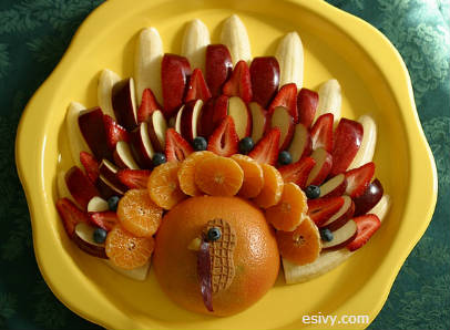 Thanksgiving Food - a fruit turkey! Kids turning up their noses at fruit ambrosia and Aunt Helen's green bean casserole? Here's an appetizer or "fruit salad" even the kids will eat! It's even a great activity at Thanksgiving meals for big families, because the children can help make it. See the blog post for tips and tricks so yours will turn out the pretty for your Thanksgiving table or buffet.