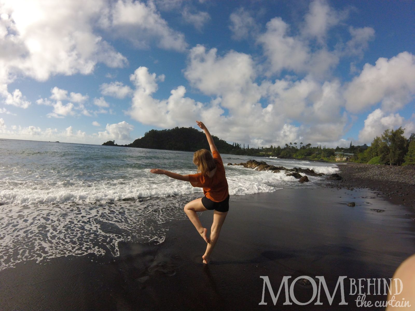 In Hawaii with teens? There's going to be lots of photos taken on the beach, like this photo of my teen girl posing on a black beach on Maui.Hawaii with teens, 8 tips for the best trip - Hawaii is one of the best places to vacation with teens. Our family vacation to Maui was one of the best we've ever had. Read on for tips about where to stay, what to do, and how to plan the best vacation ever to make memories in Hawaii with teens!